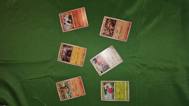 Scattered loose Pokémon cards on a table, ready to scan